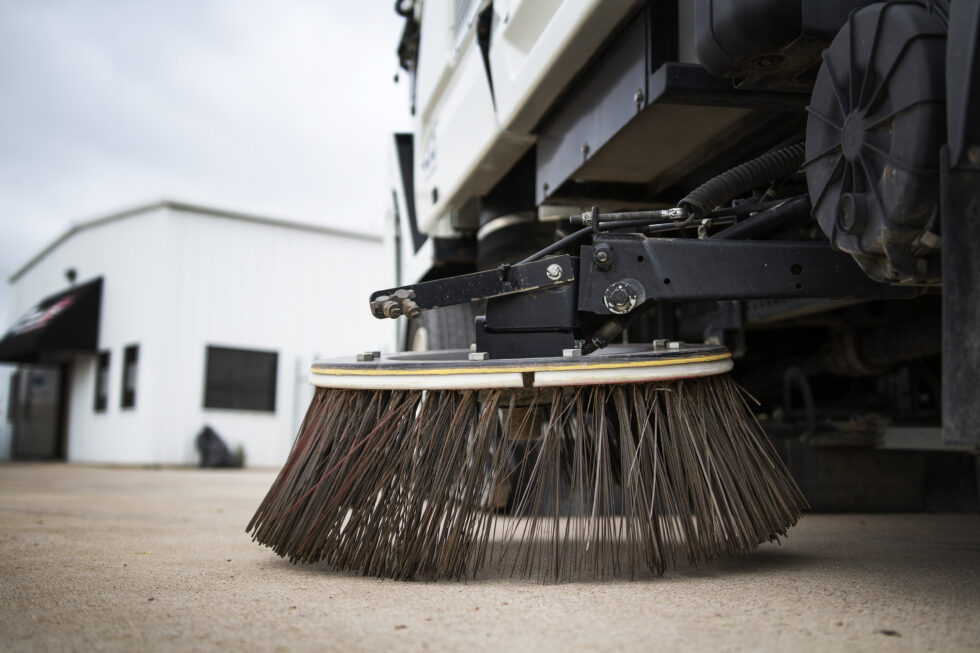 Close up of Gutter Broom on sweeper truck