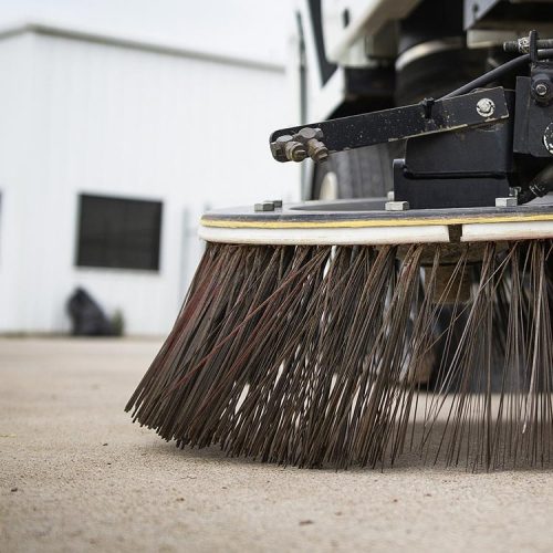 Close up of sweeper truck gutter broom