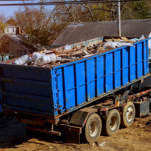 Texas Street Sweeping Service and Debris Haul Off Roll off dumpster full of debris being loaded onto a truck.
